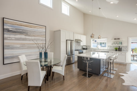 Bicycle Glass Pendant Lighting Alloy 768 in clear with single pendant hardware kits in brushed nickel, hang straights and cord lengthening over a modern white kitchen island, lights on, wide shot of vaulted ceiling, dining room, kitchen with bar stools and door to the porch