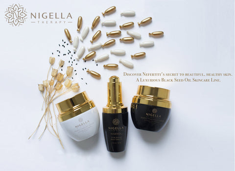 Nigella Therapy image with a photo of the three Perfecting products, the serum single pods, black seeds, and dried Nigella sativa plant stalks. Overlaid text reads: Discover Nefertiti's secret to beautiful, healthy skin. A luxurious black seed oil skincare line.