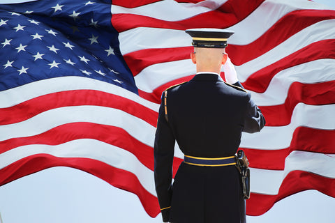 man saluting an american flag