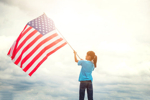 kid holding and american flag