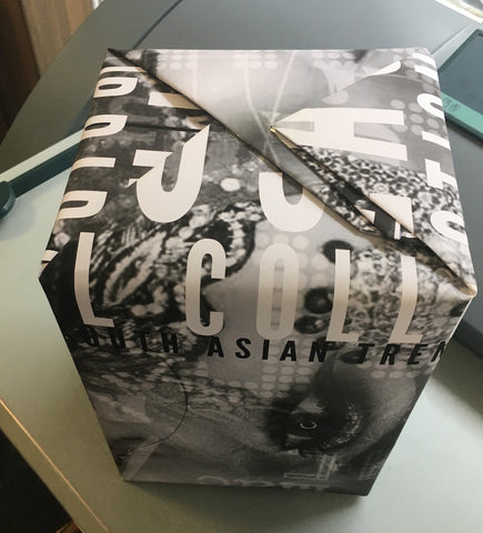 Present wrapped in bespoke printed paper. A black and white image with text.