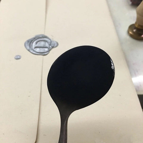 A Melting Spoon with Black Residue