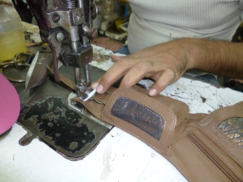 Hand stitching our boho leather money belts and fair trade handbags