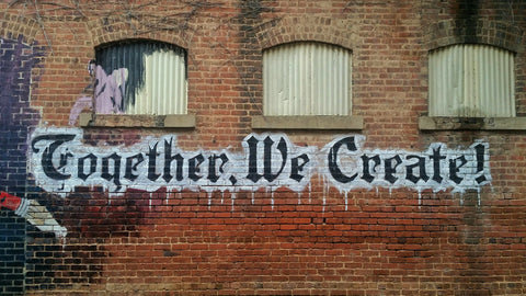 Street art reading "together we create"