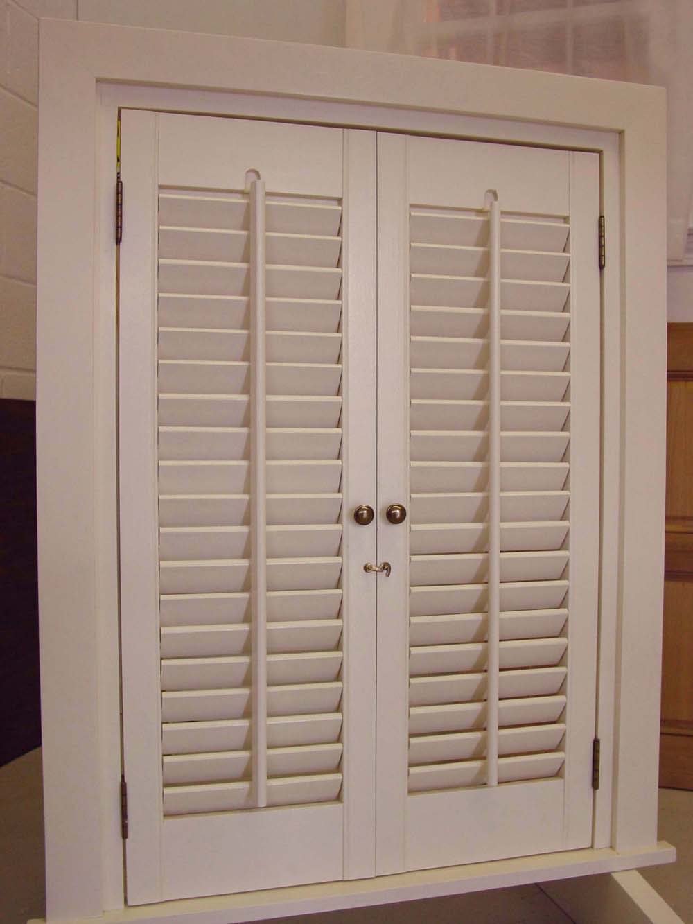 vertical mullion on interior white functional plantation style shutters