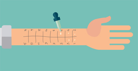 Drops of allergens placed on the forearm for skin prick allergy testing