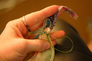 stitching the ends of the scarf necklace strips