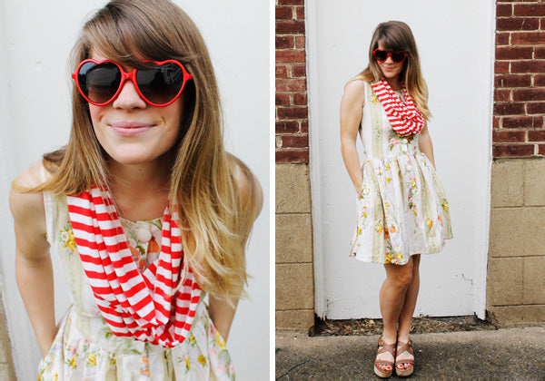 woman wearing a red and white striped scarf, heart-frame sunglasses and a floral dress - set 1