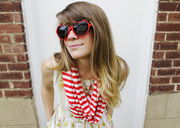 red and white striped scarf on a woman wearing heart frame sunglasses