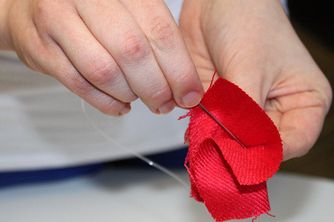 threading up the folded scarve squares for the Ombre Scarf Chandelier