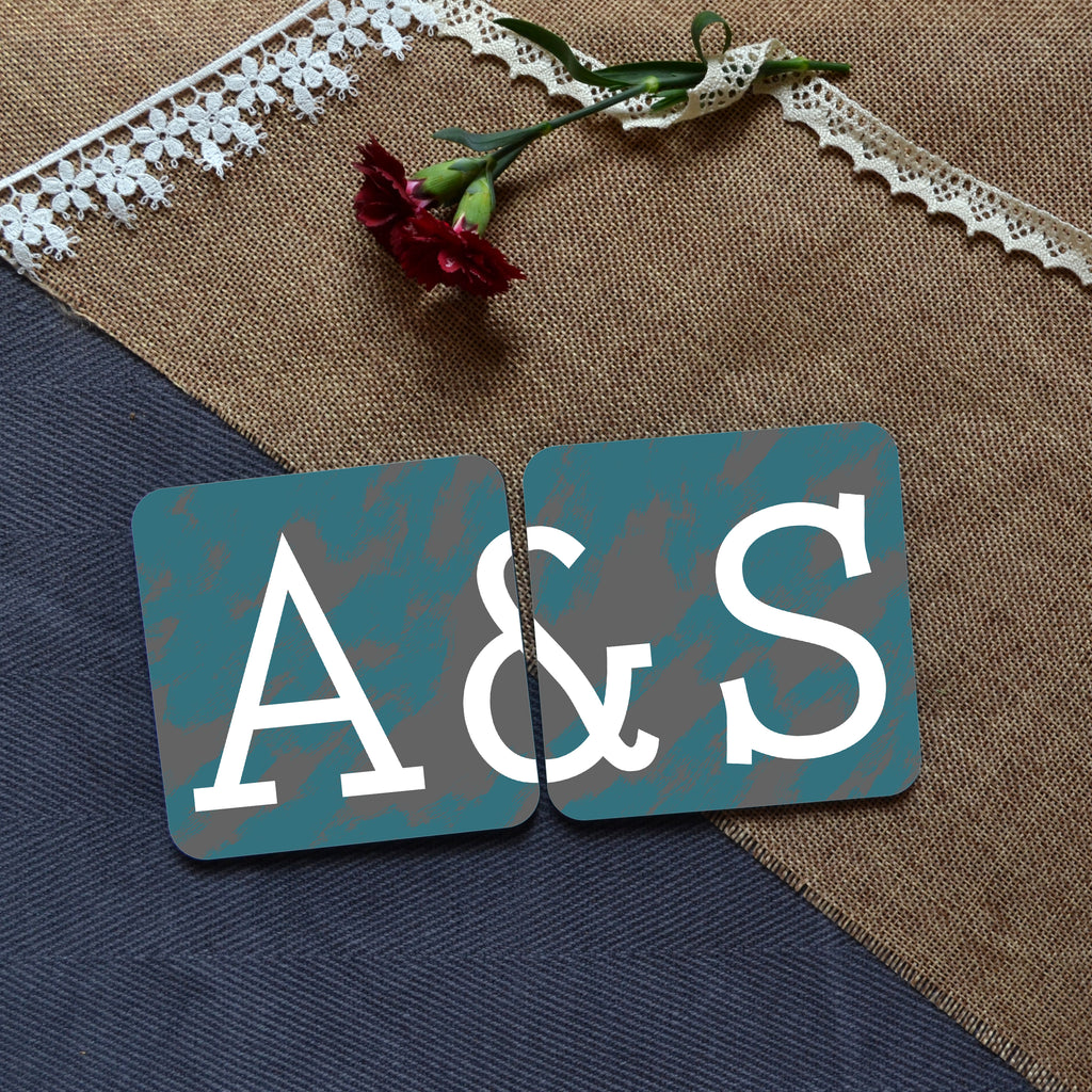 A photo of 2 personalised square coasters which when placed next to each other complete the message "A&S"