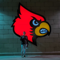 Alex in front of the Louisville Cardinal sign just before her graduation.