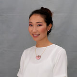 Model wearing wooden jewelry from the Furry Buddies collection by Materia Rica.