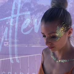 Stunning blonde woman with her hair pulled back and Glitterazzi's signature look; temple glitter. Example of glitter pulled back into the hair for affect.