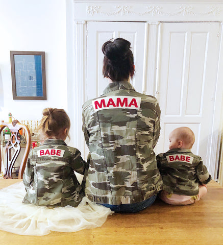 Mom and daughters wearing matching camo jackets.