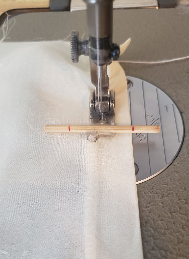 sleeve being hemmed with a shirring stitch