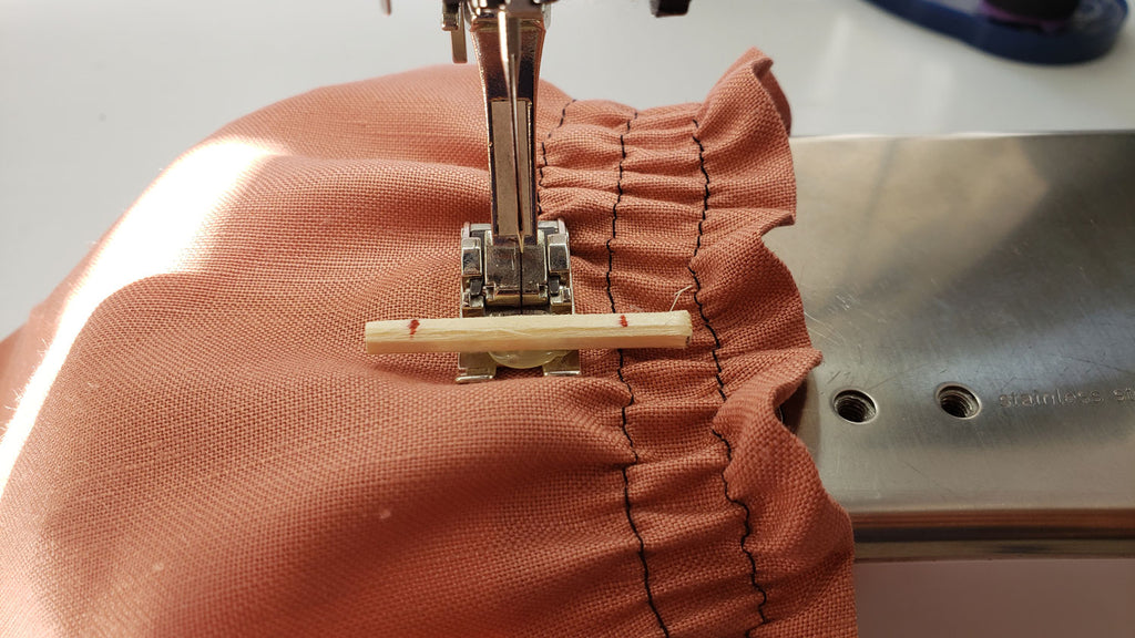 the border guide foot is shown as it sews shirring
