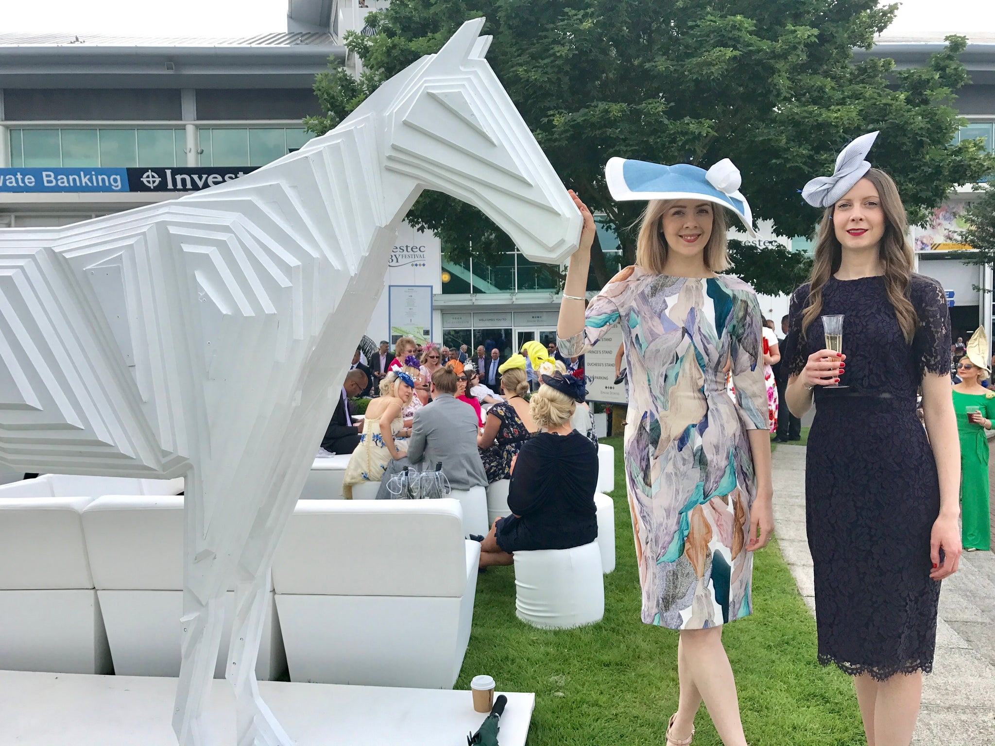 Epsom Derby Ladies Day, Two ladies wearing Louise Georgette Millinery with white horse.