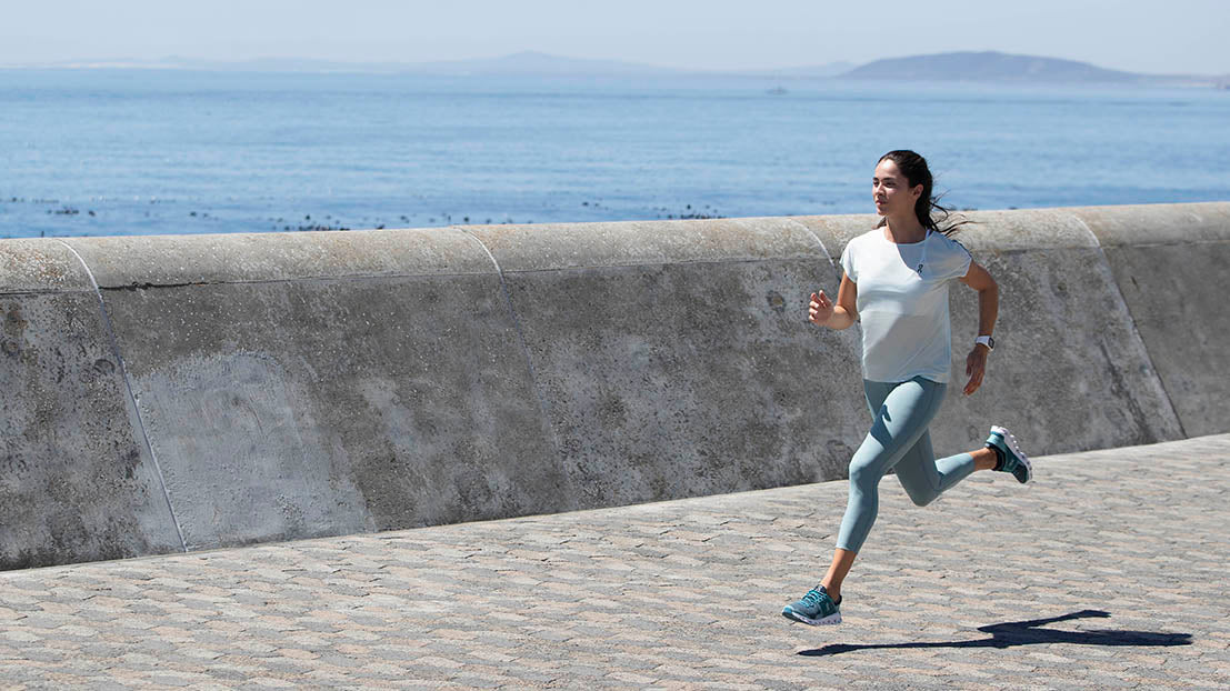 Woman running in Cloudswift Teal Storm