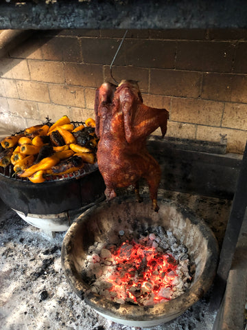 Heritage Barred Rock Chicken cooking over open fire at Claro