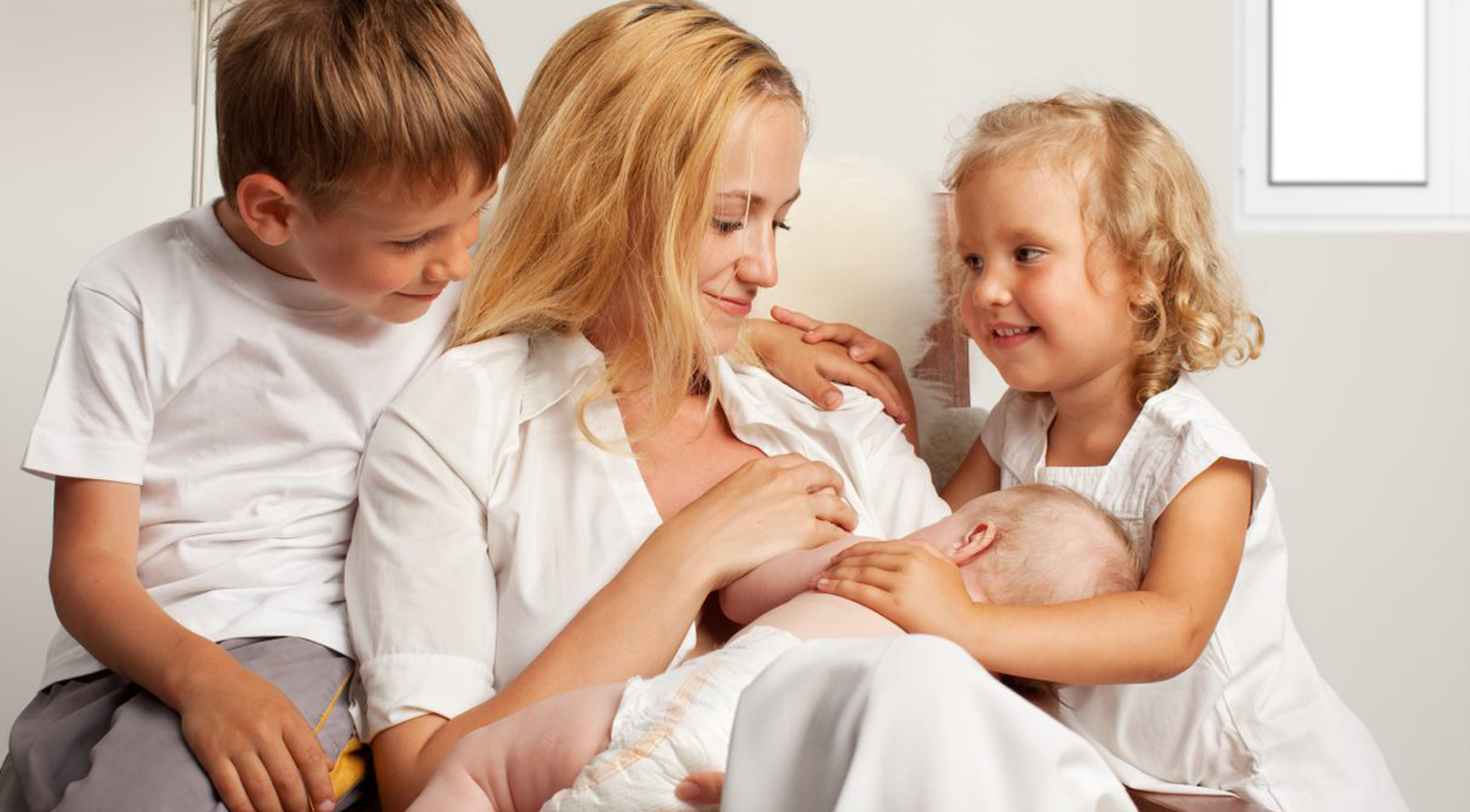 Mother with her son daughter and baby around her