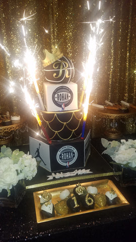 Black and Gold basketball themed cake with sparklers on it