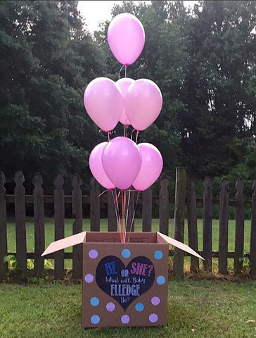 Balloon box filled with pink balloons, celebrating having a baby girl.
