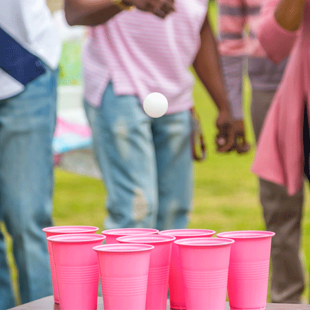Pink solo cups with a ping pong ball falling into one.