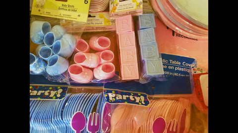 Gender reveal decoration examples including utensils and party favors. .