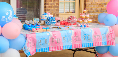Table covered with gender reveal themed food.