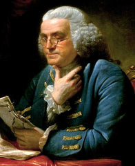 Benjamin Franklin wearing glasses and reading