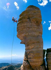 Rock climber near peak of tall rock formation