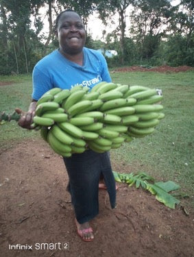 Woman carries bananas to trade for soap