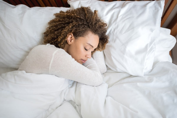 woman sleeping with a quilt