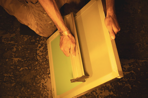 person coating a screen