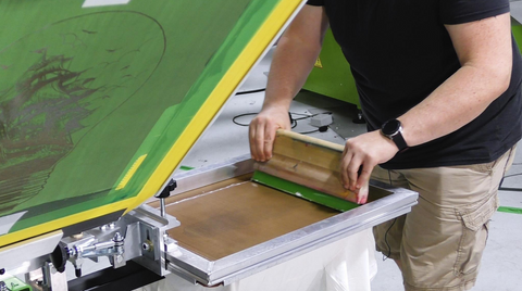 colin pulling a squeegee across a smoothing screen