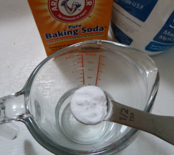 Half teaspoon baking soda dropped into quarter cup of water