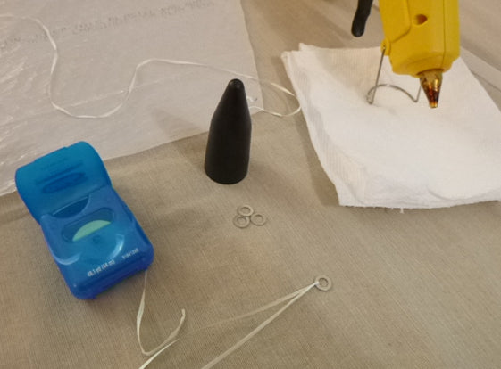 Washer tied to dental floss