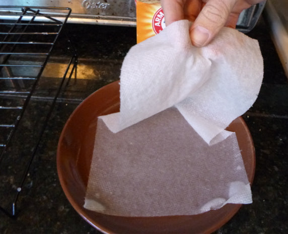 Wetting paper towel in fire retardant baking soda solution
