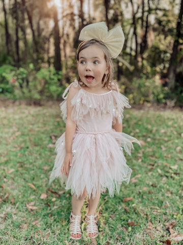 little girl with surprised look wearing Lucky Star Dress