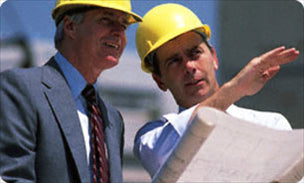 Two construction workers looking at a site