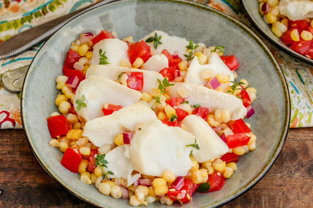 Herbed Pacific Cod, Corn, and Tomatoes is a delicious, seasonally fresh meal poaching pacific cod in herbed water and tossing it with a light dressing.