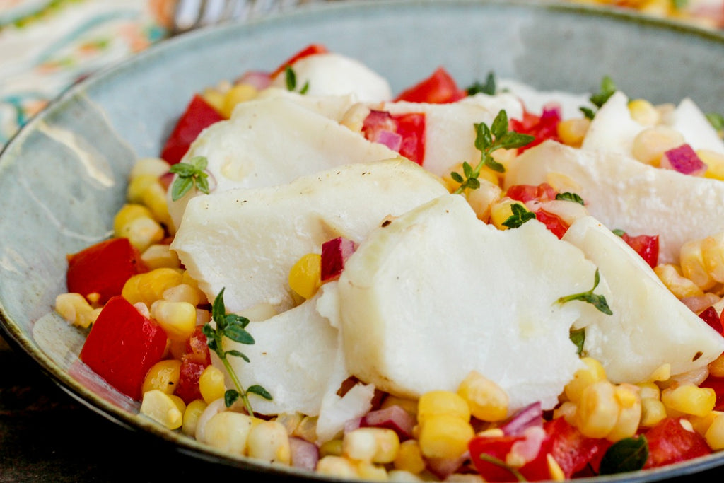 Herbed Pacific Cod, Corn, and Tomatoes is a delicious, seasonally fresh meal poaching pacific cod in herbed water and tossing it with a light dressing.