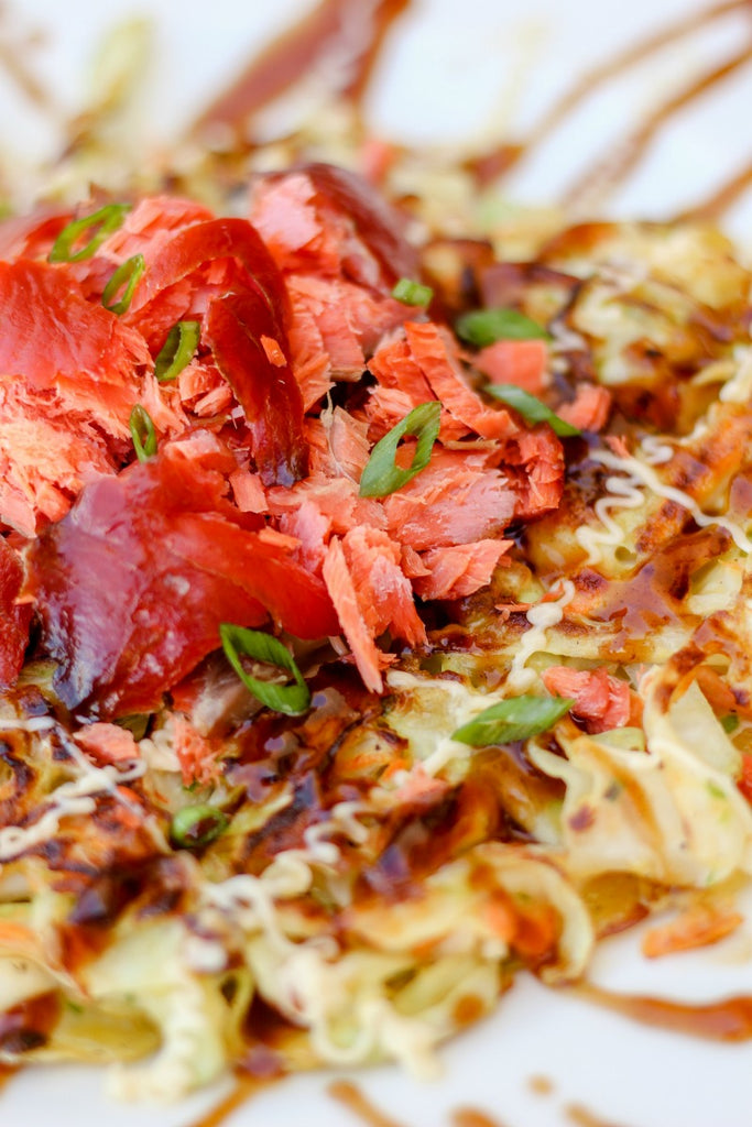 Smoked Salmon Okonomiyaki is a Japanese cabbage pancake with smoked salmon, drizzled with Japanese mayonnaise and okonomi or 'brown' sauce.