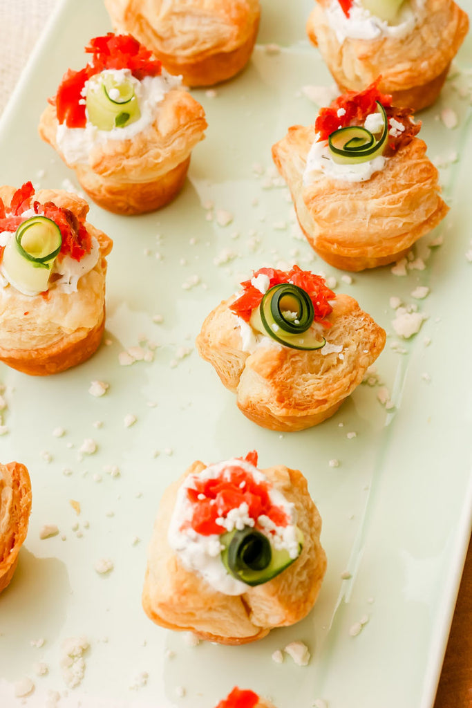 Smoked Salmon Tzatziki Puff ~ The Classic and iconic salmon puff has been given a Greek-inspired makeover with smoked salmon, tzatziki sauce, crumbled feta and a fresh cucumber curl.