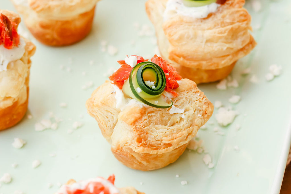 Smoked Salmon Tzatziki Puff ~ The Classic and iconic salmon puff has been given a Greek-inspired makeover with smoked salmon, tzatziki sauce, crumbled feta and a fresh cucumber curl.