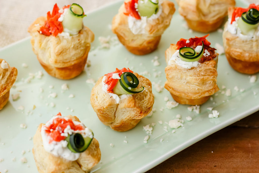 Smoked Salmon Tzatziki Puff ~ The Classic and iconic salmon puff has been given a Greek-inspired makeover with smoked salmon, tzatziki sauce, crumbled feta and a fresh cucumber curl.