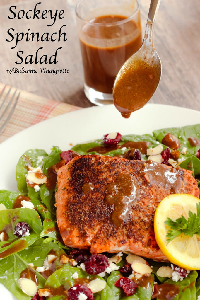 Sockeye Spinach Salad is a hearty and healthy salad with seasoned seared sockeye salmon, almonds, cranberries, and feta cheese on a crisp bed of spinach greens dressed with a tangy balsamic vinaigrette. 
