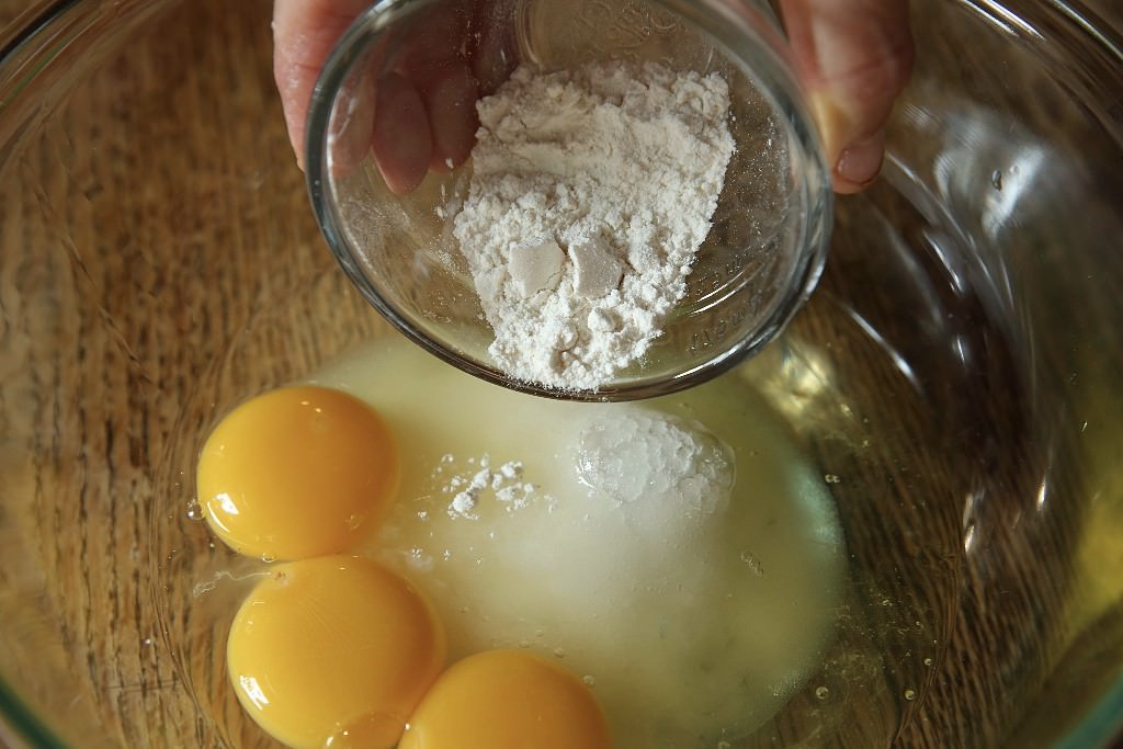 Flour added to mixture for corn pudding casserole to be baked in the Fontana wood-fired oven