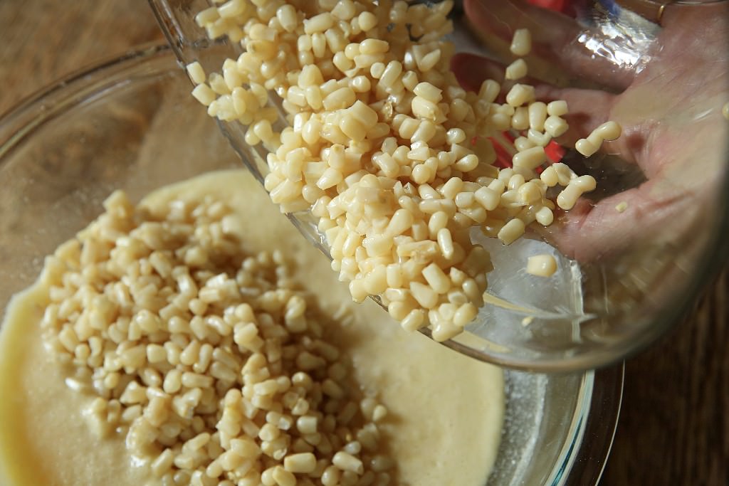 Corn added to batter for corn pudding casserole to be baked in Fontana wood-fired oven